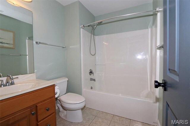 bathroom featuring tile patterned flooring, toilet, vanity, and shower / washtub combination