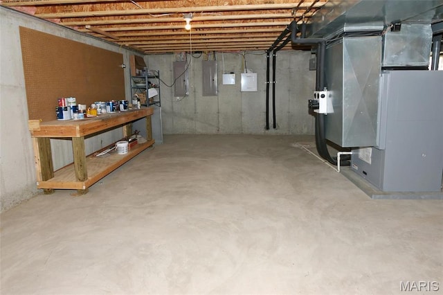 unfinished below grade area with heating unit and electric panel