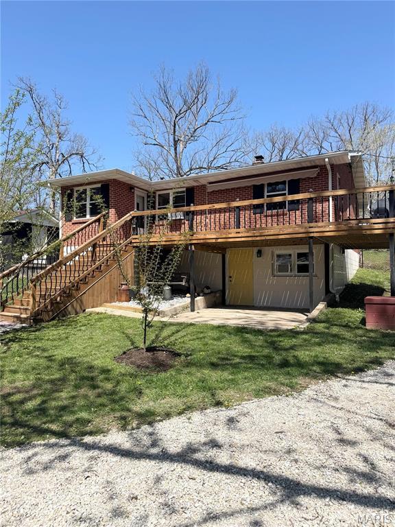 22700 Walnut St, Jerome, MO 65459 - rear view of property featuring brick siding, a deck, stairway, a yard, and a patio