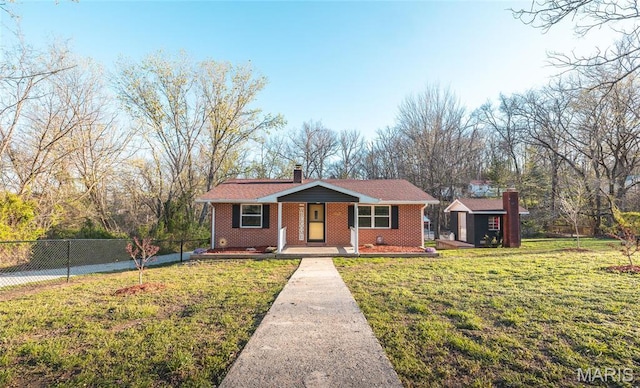 single story home with a porch, an outbuilding, a chimney, brick siding, and a storage shed