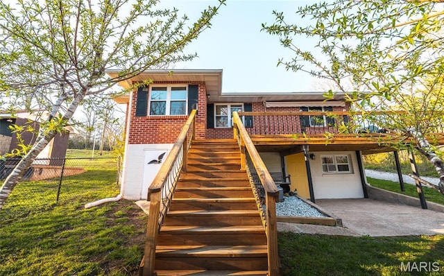 back of property featuring stairs, a wooden deck, and brick siding