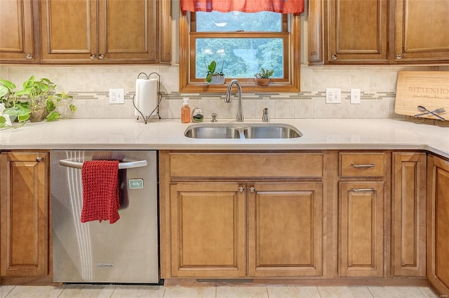 3448 Levee Rd, Centralia, IL 62801 - kitchen featuring dishwasher, a sink, light countertops, backsplash, and brown cabinets