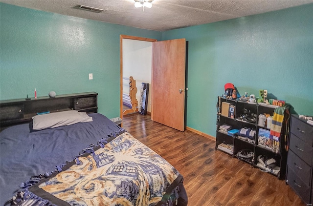 3448 Levee Rd, Centralia, IL 62801 - bedroom featuring wood finished floors, a textured wall, and a textured ceiling
