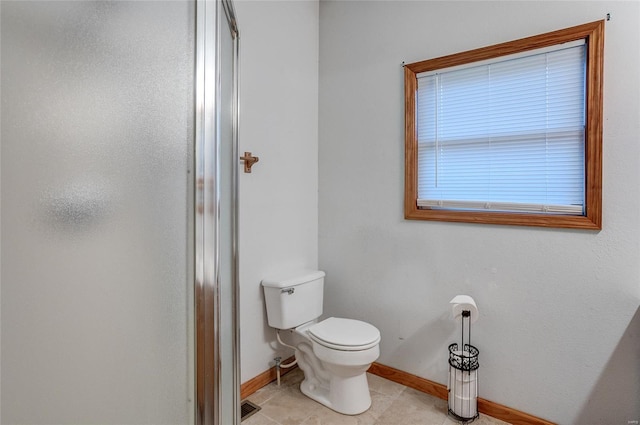 3448 Levee Rd, Centralia, IL 62801 - bathroom with baseboards, toilet, a shower with door, and tile patterned floors