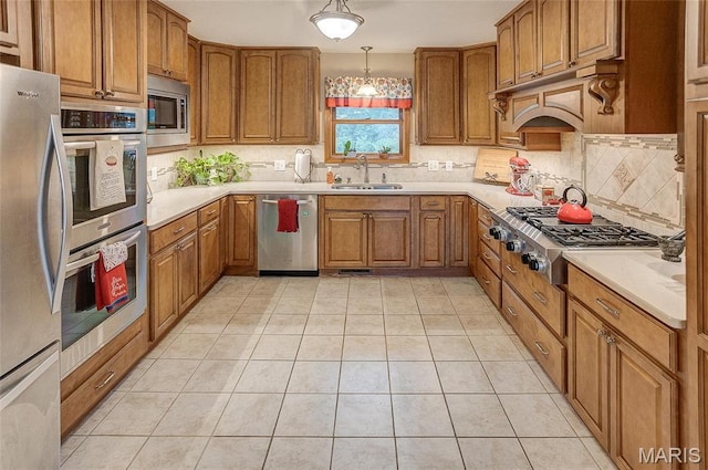 3448 Levee Rd, Centralia, IL 62801 - kitchen featuring stainless steel appliances, a sink, brown cabinets, and decorative backsplash