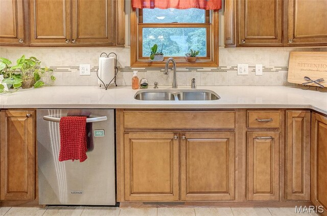 3448 Levee Rd, Centralia, IL 62801 - kitchen featuring dishwasher, a sink, light countertops, tasteful backsplash, and brown cabinetry