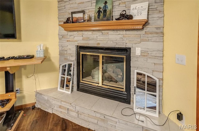 3448 Levee Rd, Centralia, IL 62801 - detailed view of a stone fireplace, baseboards, and wood finished floors