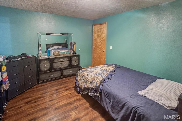 3448 Levee Rd, Centralia, IL 62801 - bedroom with wood finished floors, a textured wall, and a textured ceiling
