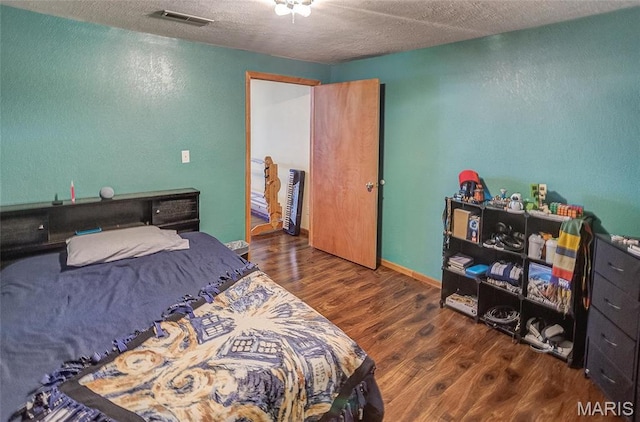 3448 Levee Rd, Centralia, IL 62801 - bedroom with wood finished floors, a textured wall, and a textured ceiling