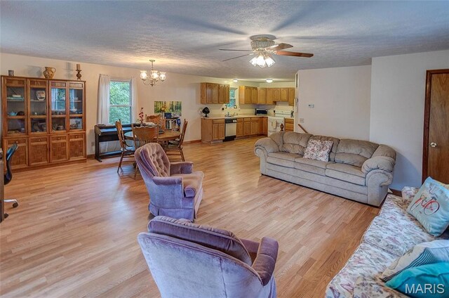 3448 Levee Rd, Centralia, IL 62801 - living room with a chandelier, a ceiling fan, light wood-style flooring, and a textured ceiling