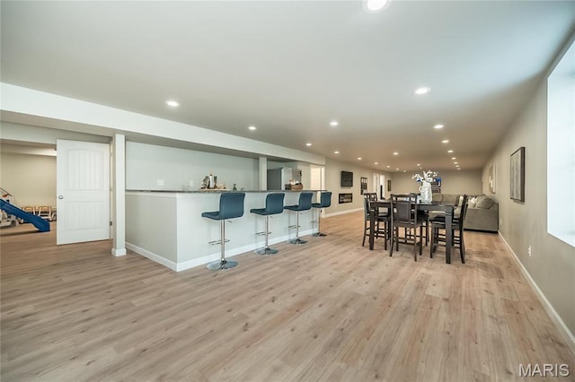 2181 Jarvis Rd, Foristell, MO 63348 - dining space featuring light wood-style flooring, baseboards, recessed lighting, and bar area