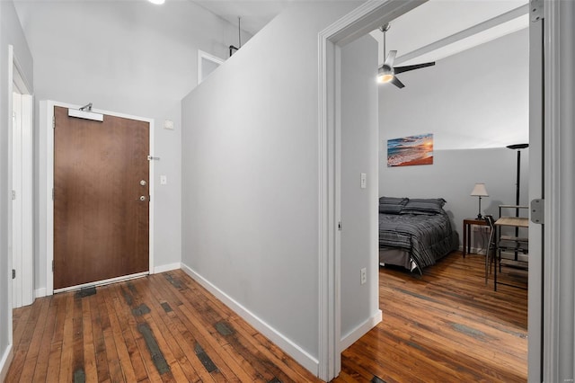 hall with hardwood / wood-style flooring and baseboards