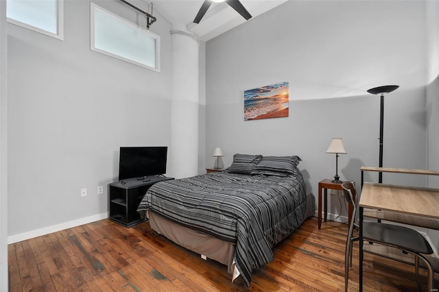 bedroom featuring hardwood / wood-style floors and baseboards