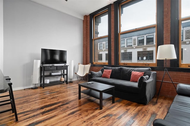 living room featuring wood-type flooring and baseboards