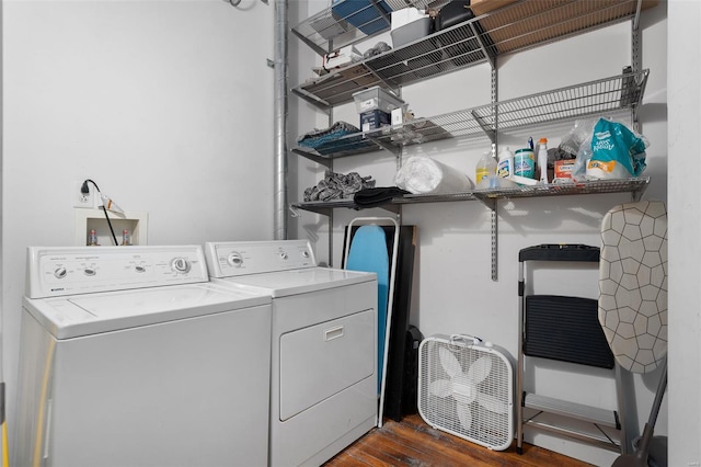 laundry area with washer and dryer and dark wood finished floors
