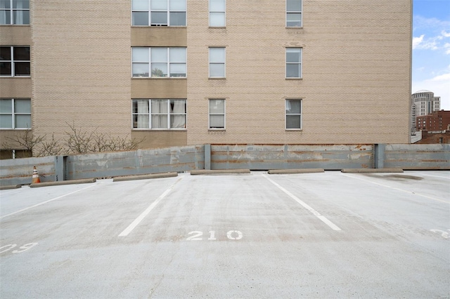 uncovered parking lot featuring fence