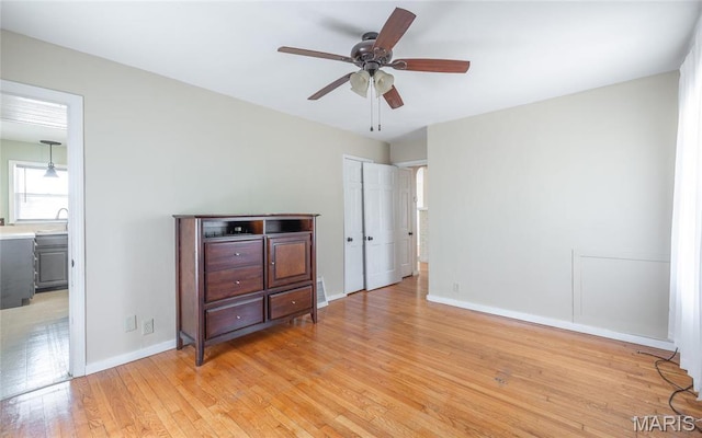 11 Rolla Gardens Dr, Rolla, MO 65401 - unfurnished bedroom with light wood-style floors, baseboards, and ceiling fan