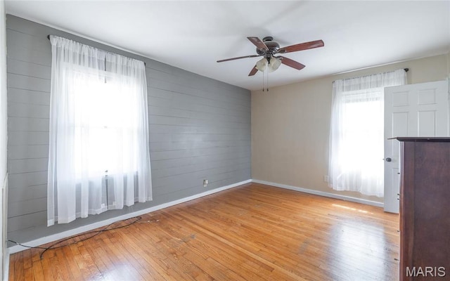11 Rolla Gardens Dr, Rolla, MO 65401 - unfurnished room featuring light wood-style flooring, ceiling fan, and wood walls