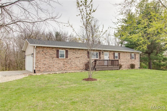 single story home featuring brick siding, driveway, a garage, and a front yard
