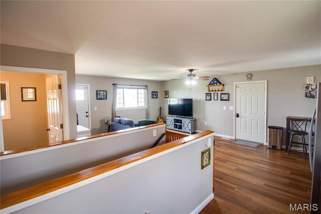 corridor with dark wood-style floors and baseboards