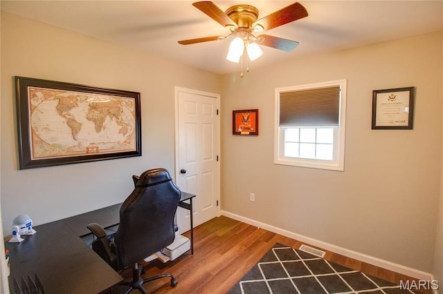 home office featuring wood finished floors, baseboards, and a ceiling fan