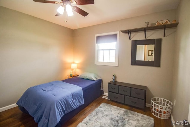 bedroom with baseboards, wood finished floors, and a ceiling fan