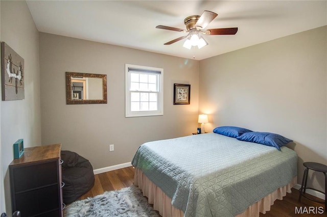 bedroom with baseboards, wood finished floors, and a ceiling fan