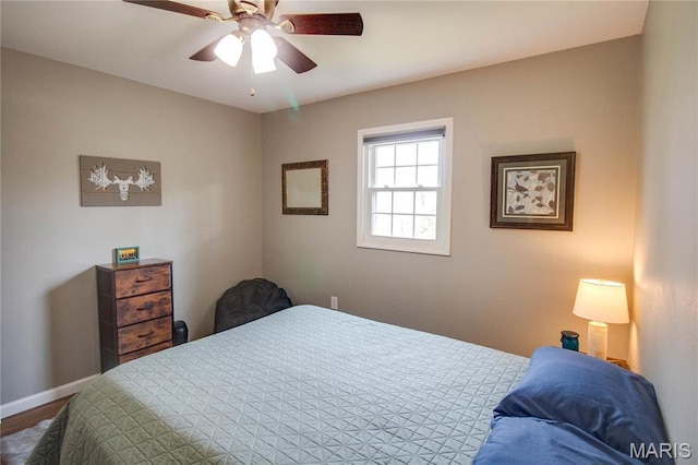 bedroom featuring baseboards and ceiling fan