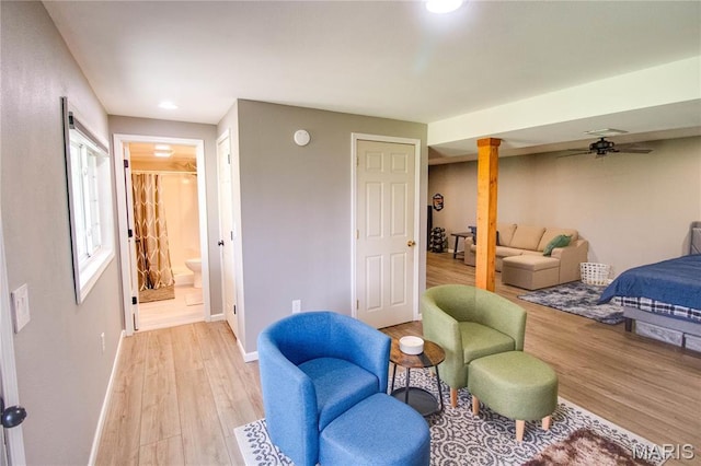 bedroom with light wood-style flooring, baseboards, ensuite bath, and recessed lighting