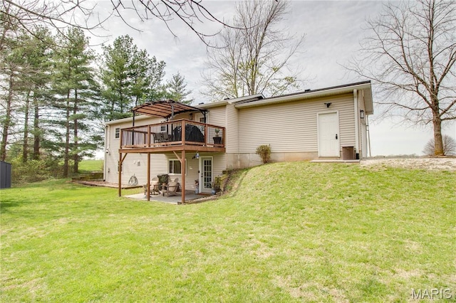 rear view of property with a patio, a deck, and a lawn