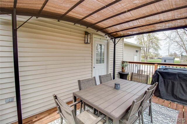 wooden deck featuring outdoor dining area