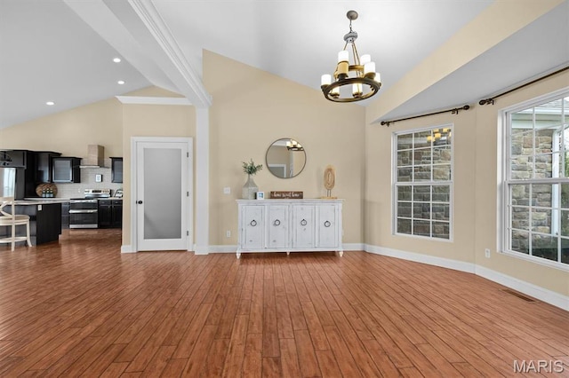 2 Arthurs Ct, Troy, IL 62294 - unfurnished dining area featuring a chandelier, baseboards, dark wood-type flooring, and high vaulted ceiling