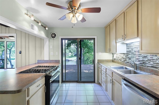 135 Hollyhock Ln, Edwardsville, IL 62025 - kitchen with stainless steel appliances, a sink, a ceiling fan, and decorative backsplash