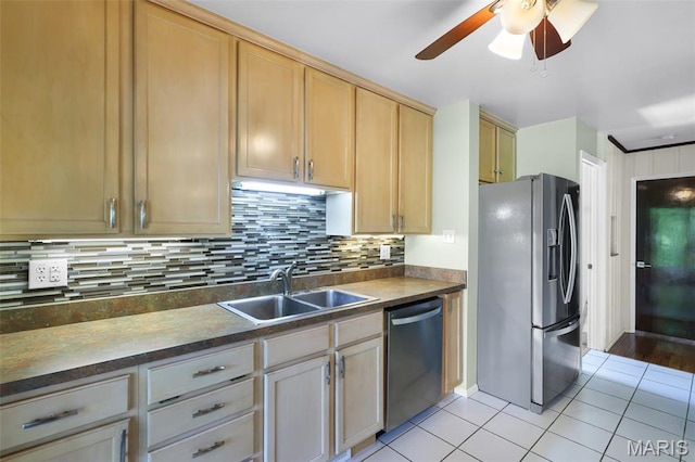135 Hollyhock Ln, Edwardsville, IL 62025 - kitchen with appliances with stainless steel finishes, a sink, light tile patterned flooring, a ceiling fan, and dark countertops