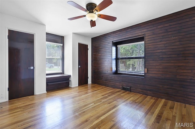 135 Hollyhock Ln, Edwardsville, IL 62025 - spare room featuring healthy amount of natural light, a ceiling fan, hardwood / wood-style floors, and wood walls
