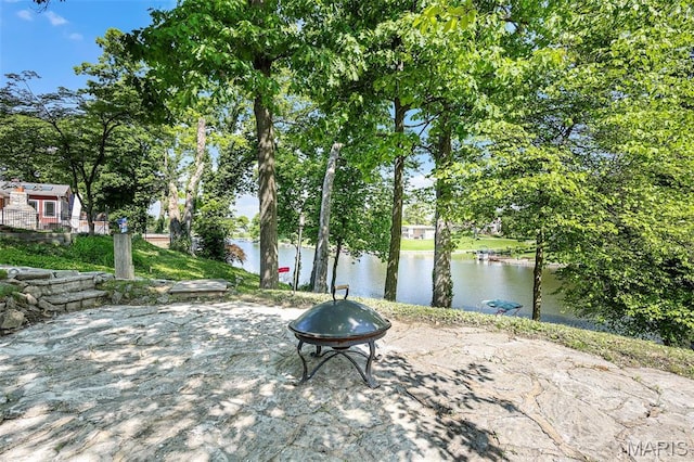 135 Hollyhock Ln, Edwardsville, IL 62025 - view of patio featuring an outdoor fire pit, a water view, and view of scattered trees