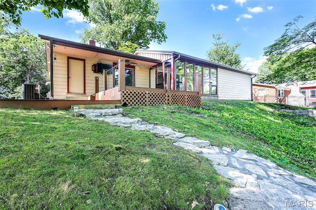 135 Hollyhock Ln, Edwardsville, IL 62025 - view of front of house with central AC unit, a front lawn, and a chimney