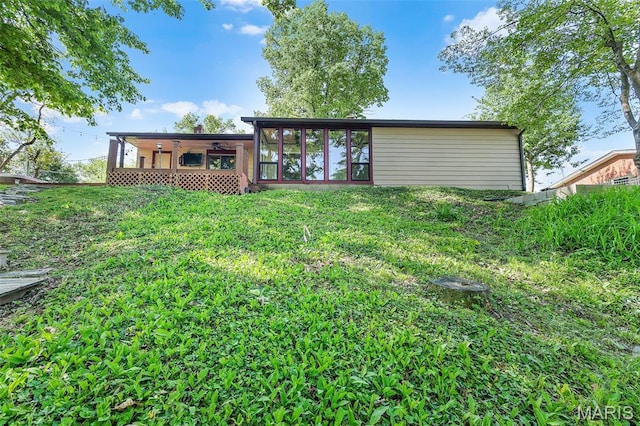 135 Hollyhock Ln, Edwardsville, IL 62025 - back of house featuring a sunroom, ceiling fan, and a yard