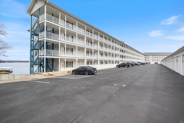 18011 Blue Anchor Dr Unit 132, Gravois Mills, MO 65037 - view of apartment building / complex featuring stairs and uncovered parking