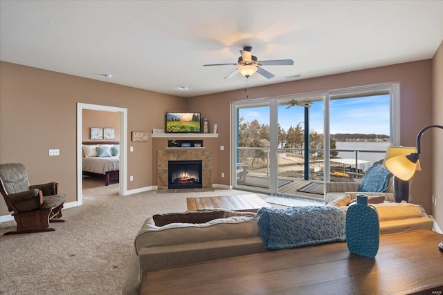 18011 Blue Anchor Dr Unit 132, Gravois Mills, MO 65037 - living area featuring a ceiling fan, a fireplace, baseboards, and light colored carpet