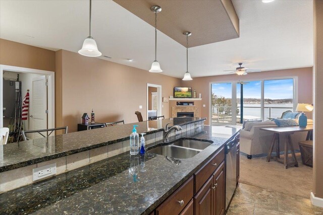 18011 Blue Anchor Dr Unit 132, Gravois Mills, MO 65037 - kitchen featuring a sink, dishwasher, a fireplace, open floor plan, and decorative light fixtures