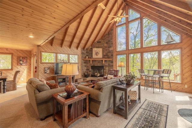 2099 Meadow Valley Dr, Innsbrook, MO 63390 - living area featuring a stone fireplace, wooden walls, high vaulted ceiling, light carpet, and beamed ceiling