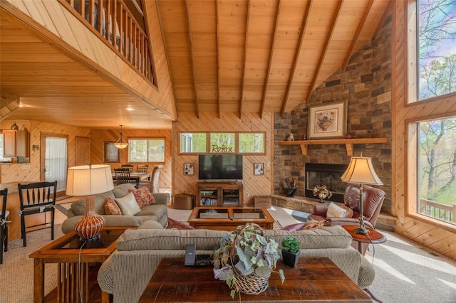 2099 Meadow Valley Dr, Innsbrook, MO 63390 - living area featuring wood walls, wooden ceiling, carpet flooring, beam ceiling, and a stone fireplace