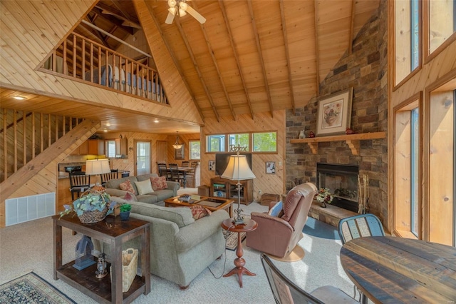 2099 Meadow Valley Dr, Innsbrook, MO 63390 - carpeted living room with high vaulted ceiling, wooden walls, healthy amount of natural light, ceiling fan, and wood ceiling