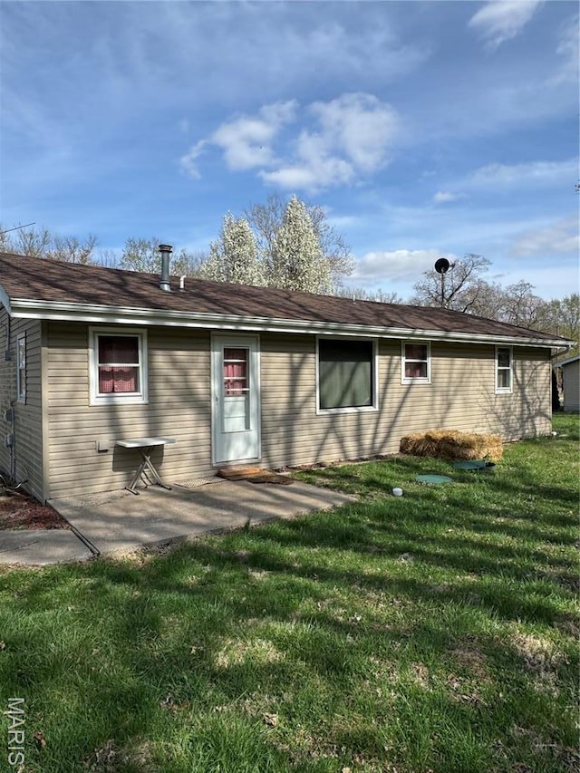 13899 Riverview Dr, New London, MO 63459 - back of house with a lawn and a patio area
