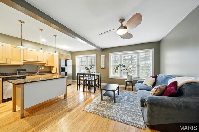 4228 Mcpherson Ave Unit 212, Saint Louis, MO 63108 - living room featuring a ceiling fan, light wood-type flooring, beam ceiling, and baseboards