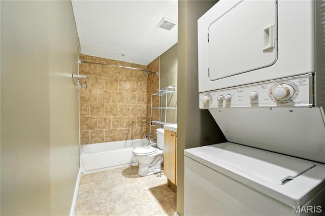 4228 Mcpherson Ave Unit 212, Saint Louis, MO 63108 - full bath with stacked washing machine and dryer, shower / tub combination, toilet, baseboards, and vanity