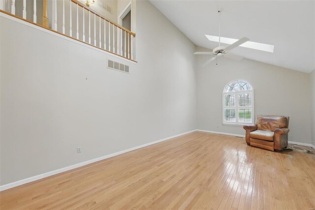 7426 Whitehall Colonial Ln, Saint Louis, MO 63119 - unfurnished room featuring a skylight, high vaulted ceiling, hardwood / wood-style flooring, ceiling fan, and baseboards