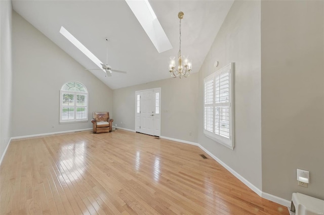 7426 Whitehall Colonial Ln, Saint Louis, MO 63119 - entryway with a skylight, a chandelier, high vaulted ceiling, light wood-type flooring, and baseboards