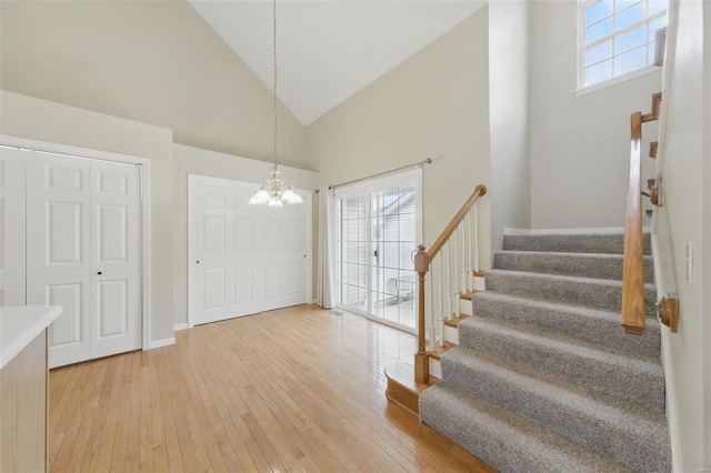 7426 Whitehall Colonial Ln, Saint Louis, MO 63119 - foyer entrance with a chandelier, stairway, healthy amount of natural light, high vaulted ceiling, and light wood finished floors